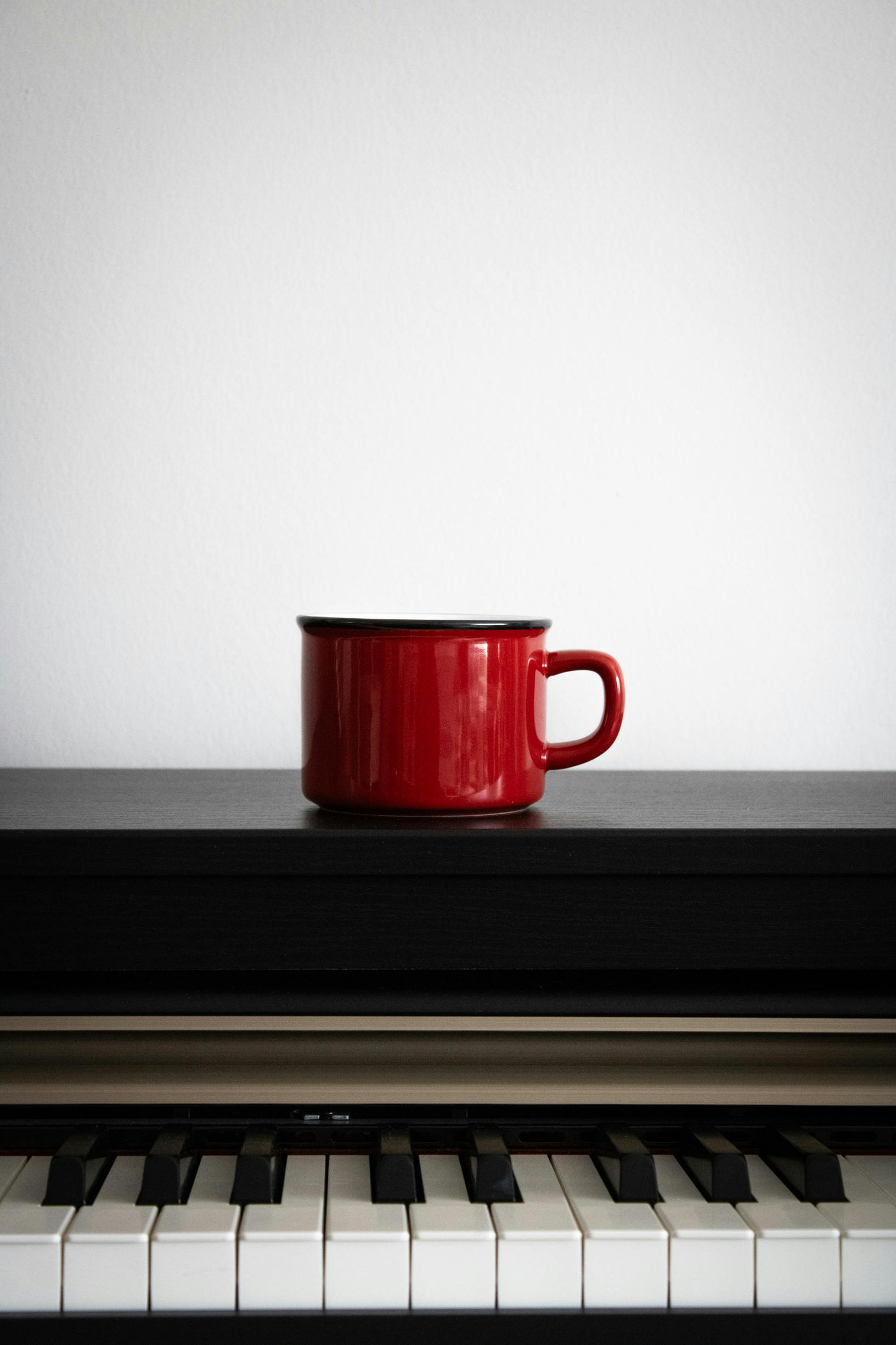 a red cup on a piano